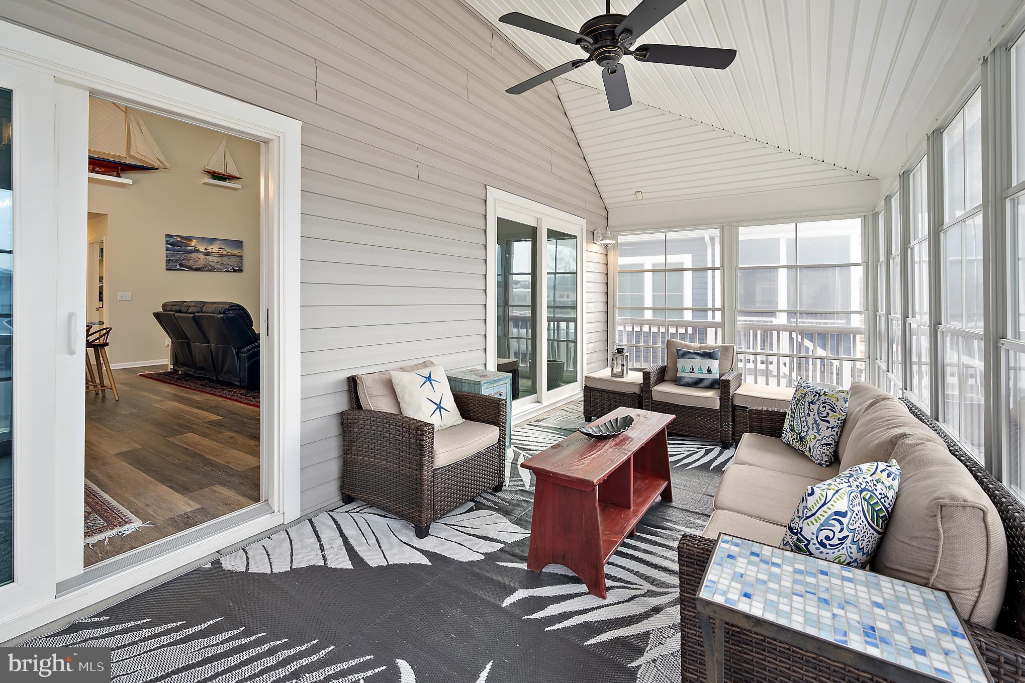 144 Clamshell Road Ocean City, MD 21842 - Photo 49 of 64 a living room with furniture and a large window