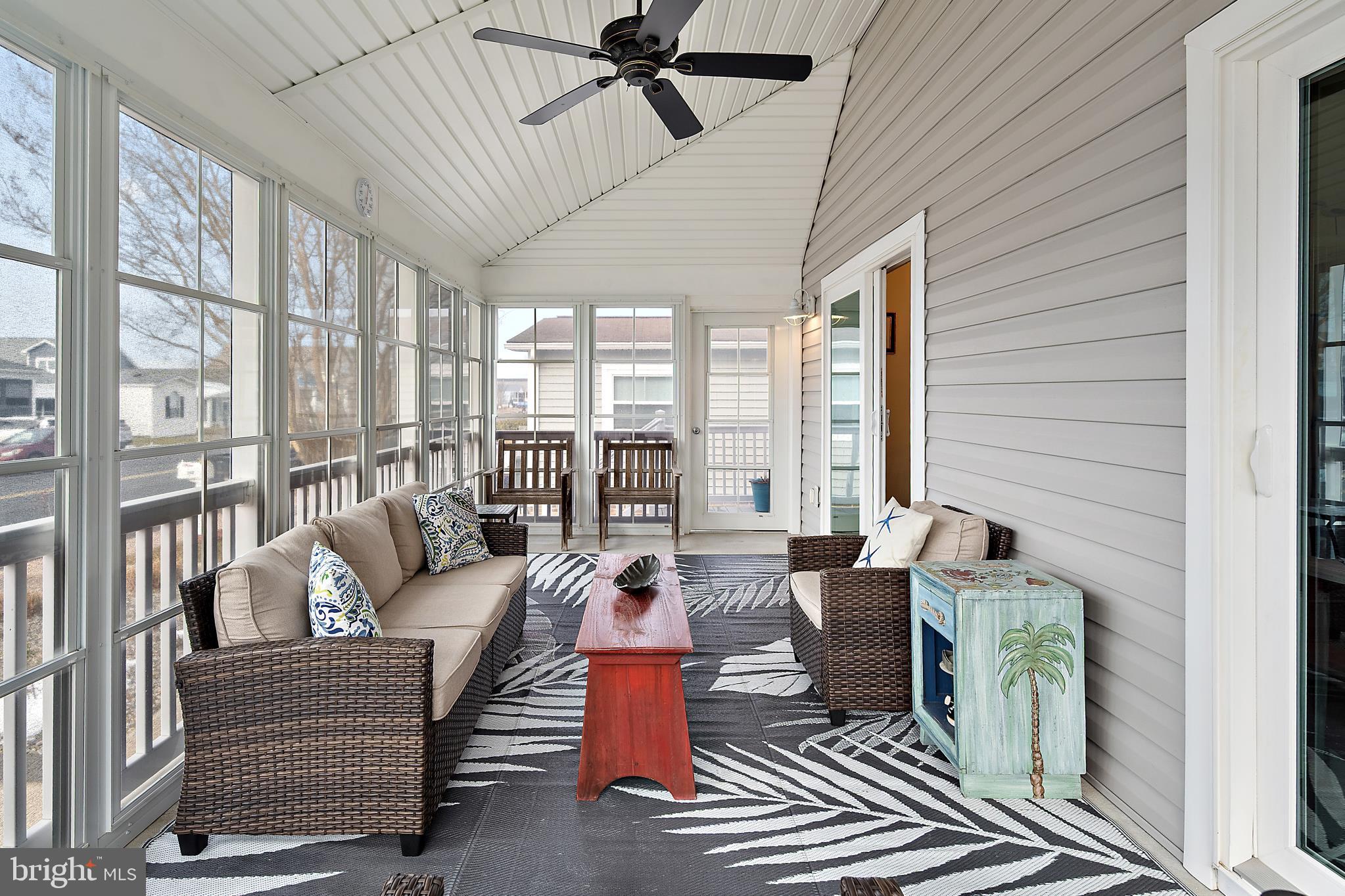 144 Clamshell Road Ocean City, MD 21842 - Photo 51 of 64 a living room with furniture and a large window