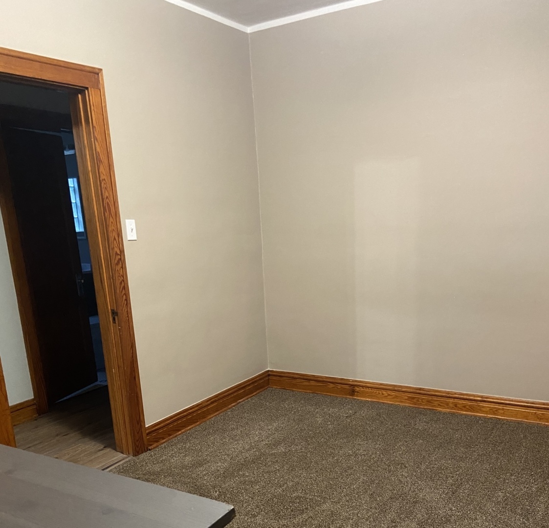 4818 South Springfield Avenue Chicago, IL 60632 - Photo 12 of 36 an empty room with a door