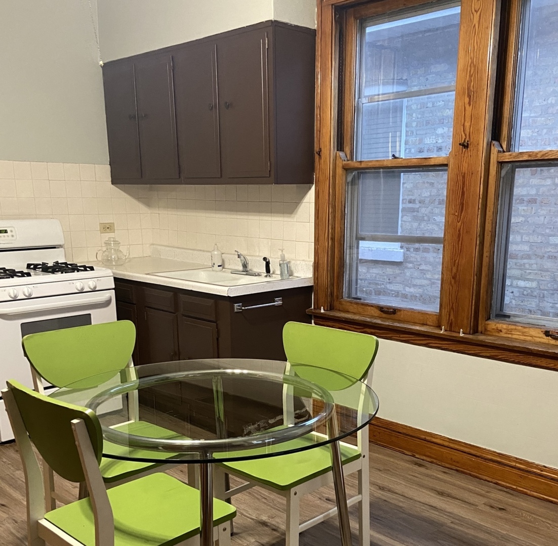 4818 South Springfield Avenue Chicago, IL 60632 - Photo 14 of 36 a kitchen with a sink cabinets and a window