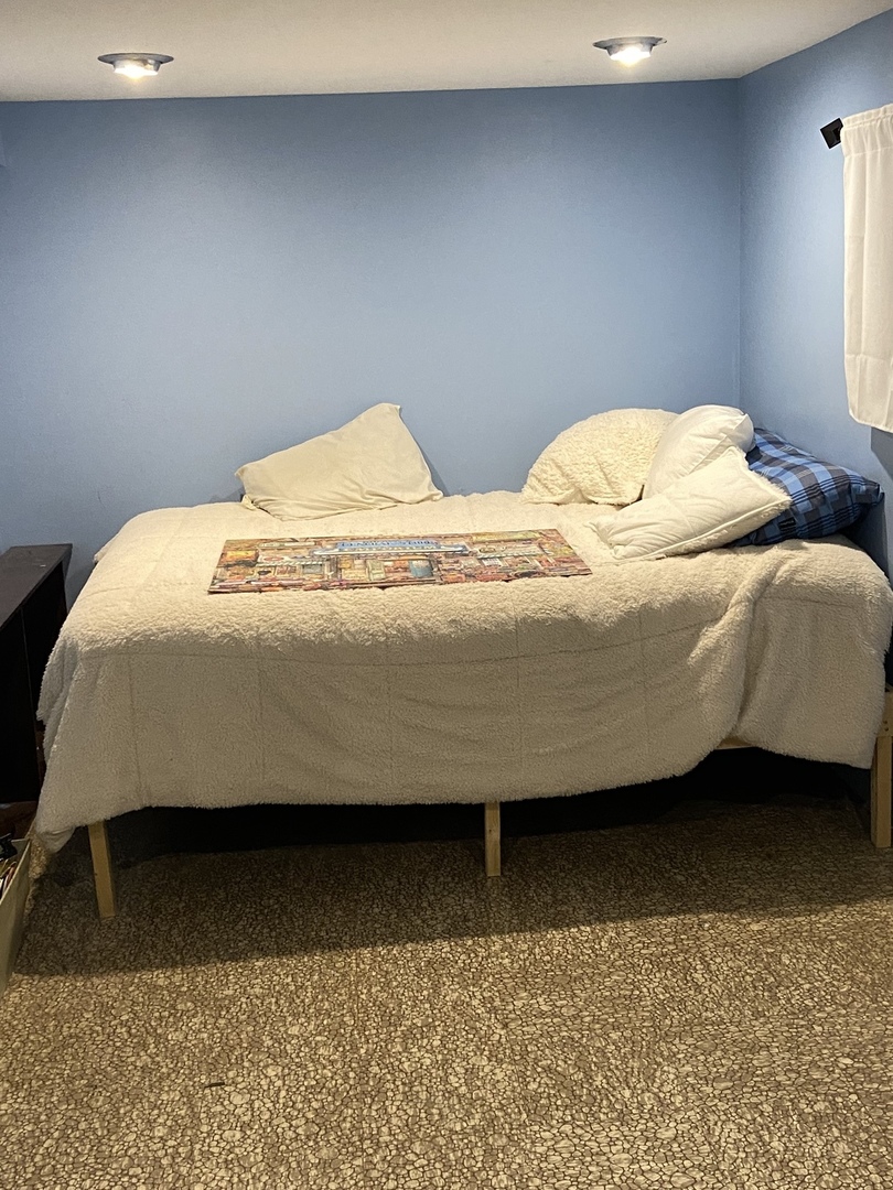 4818 South Springfield Avenue Chicago, IL 60632 - Photo 17 of 36 a bedroom with a bed and window