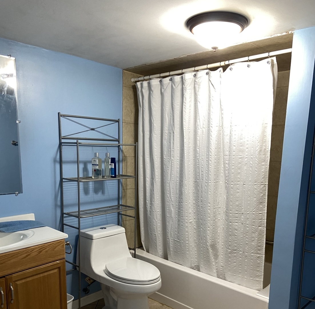 4818 South Springfield Avenue Chicago, IL 60632 - Photo 18 of 36 a white toilet sitting next to a bathroom sink