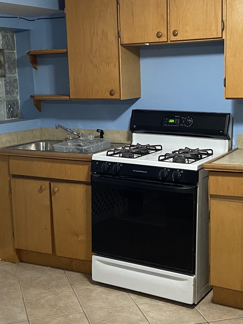 4818 South Springfield Avenue Chicago, IL 60632 - Photo 20 of 36 a stove top oven sitting inside of a kitchen