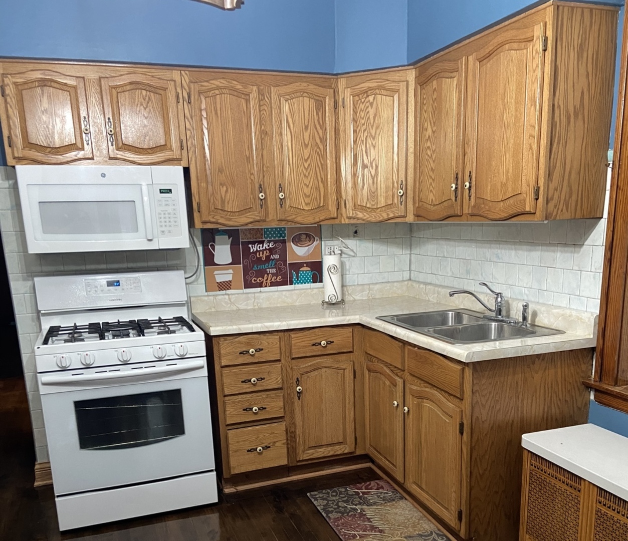 4818 South Springfield Avenue Chicago, IL 60632 - Photo 22 of 36 a kitchen with a sink stove and cabinets