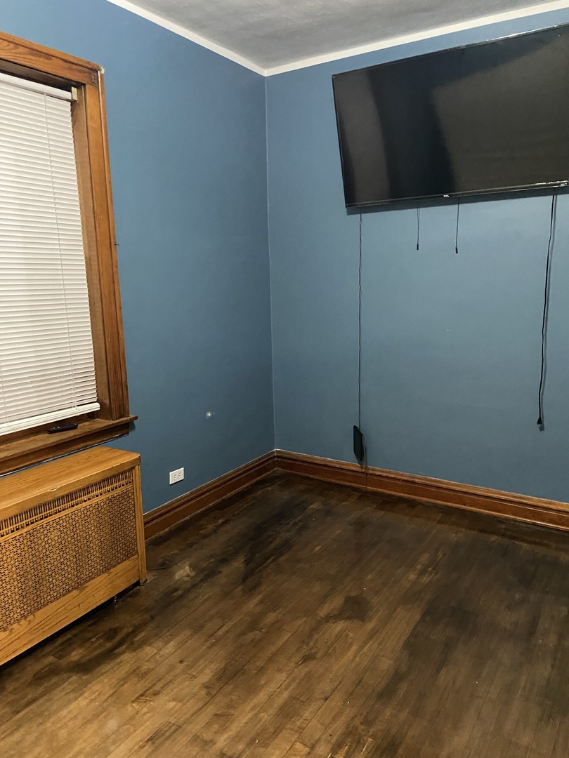 4818 South Springfield Avenue Chicago, IL 60632 - Photo 32 of 36 a view of an empty room with wooden floor and a window
