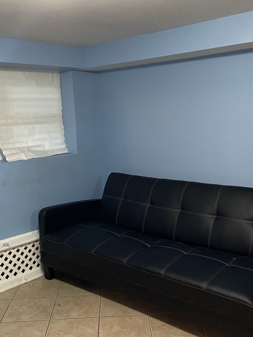 4818 South Springfield Avenue Chicago, IL 60632 - Photo 36 of 36 a couch sitting in a bedroom next to a window