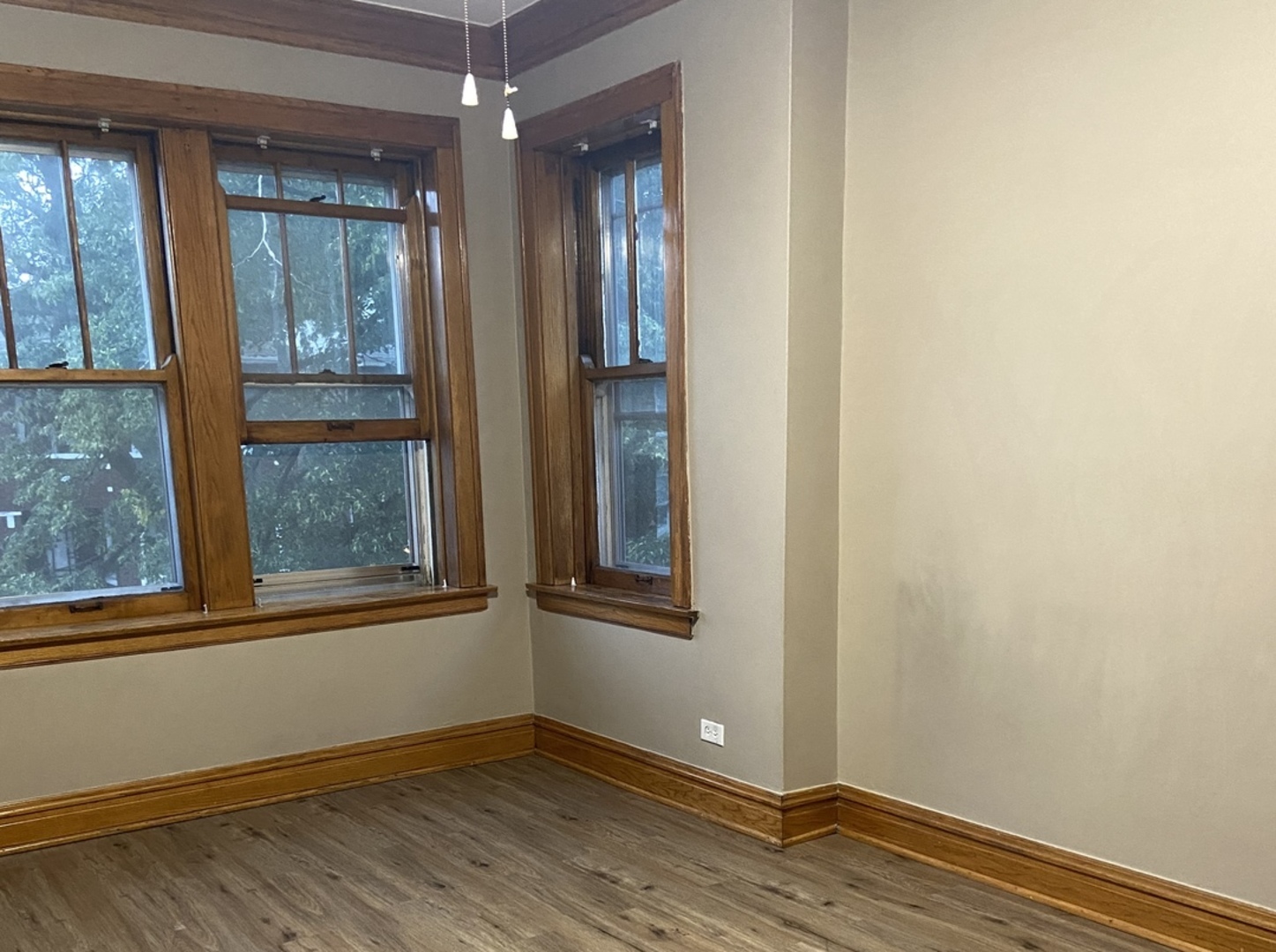 4818 South Springfield Avenue Chicago, IL 60632 - Photo 9 of 36 an empty room with wooden floor and windows