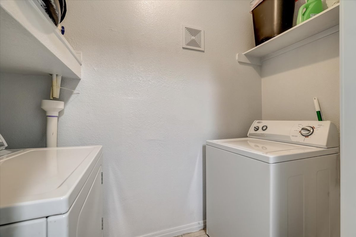2515 Pearl Street, Unit 206 Austin, TX 78705 - Photo 1 of 11 Laundry area with washing machine and dryer and a textured wall