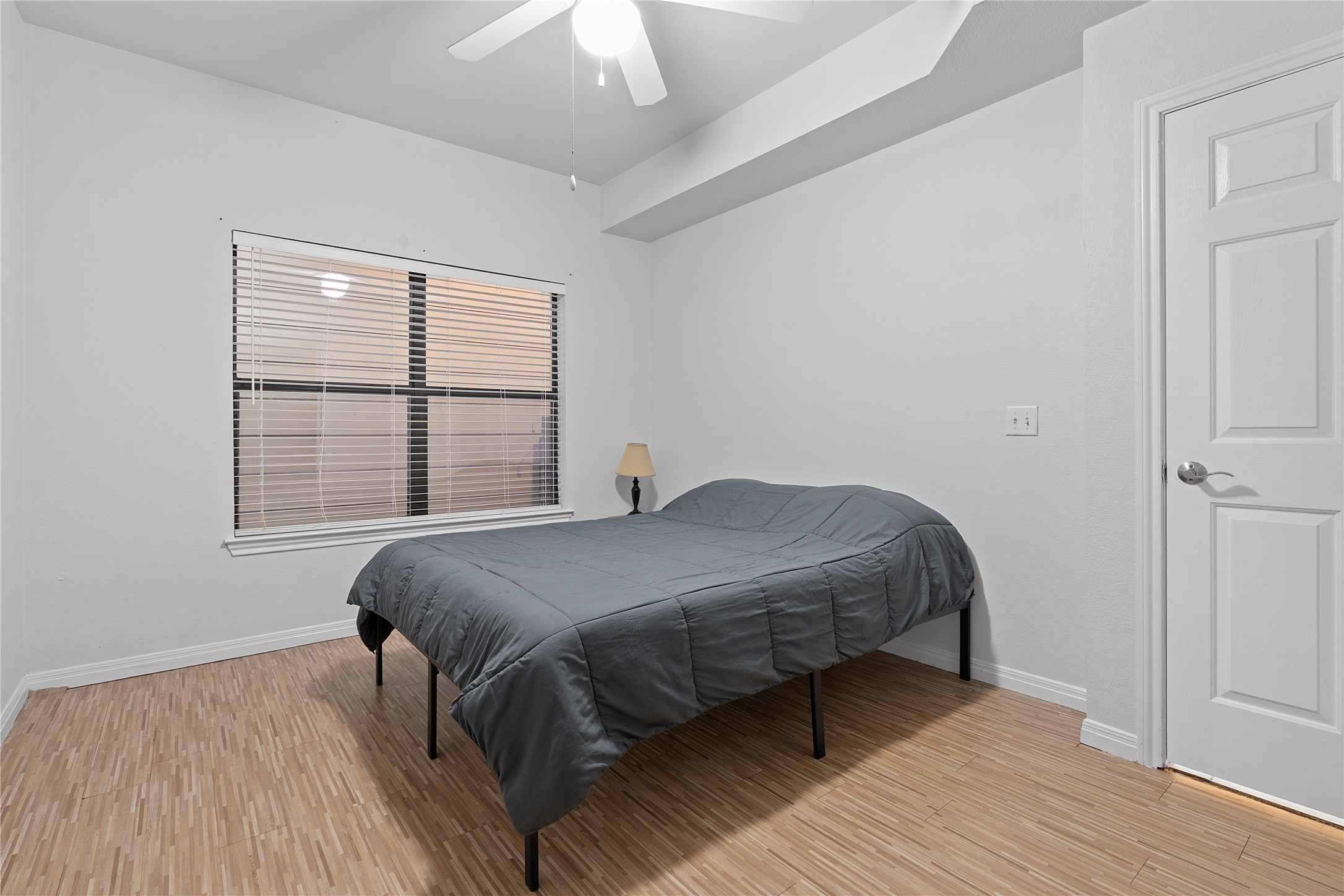 2515 Pearl Street, Unit 206 Austin, TX 78705 - Photo 11 of 11 Bedroom with light wood finished floors and a ceiling fan
