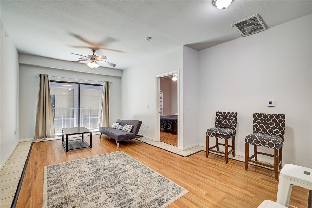 2515 Pearl Street, Unit 206 Austin, TX 78705 - Photo 5 of 11 Sitting room featuring light wood-style floors and a ceiling fan