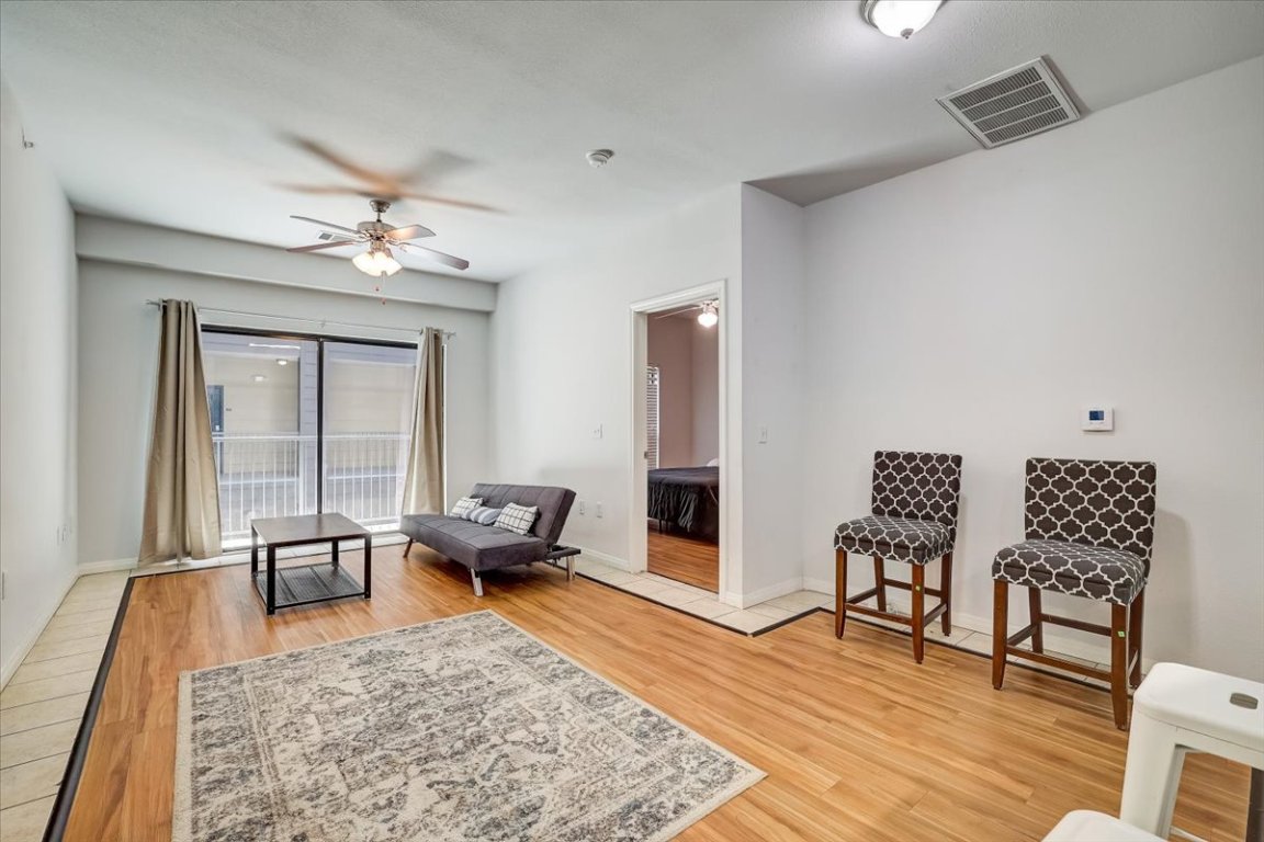 2515 Pearl Street, Unit 410 Austin, TX 78705 - Photo 5 of 11 a living room with furniture and wooden floor