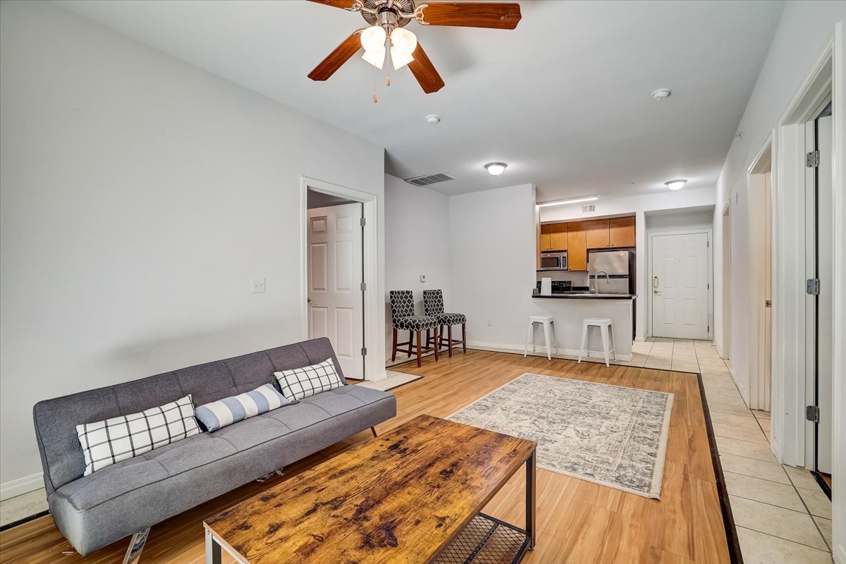 2515 Pearl Street, Unit 206 Austin, TX 78705 - Photo 6 of 11 Living area featuring light wood-type flooring and ceiling fan