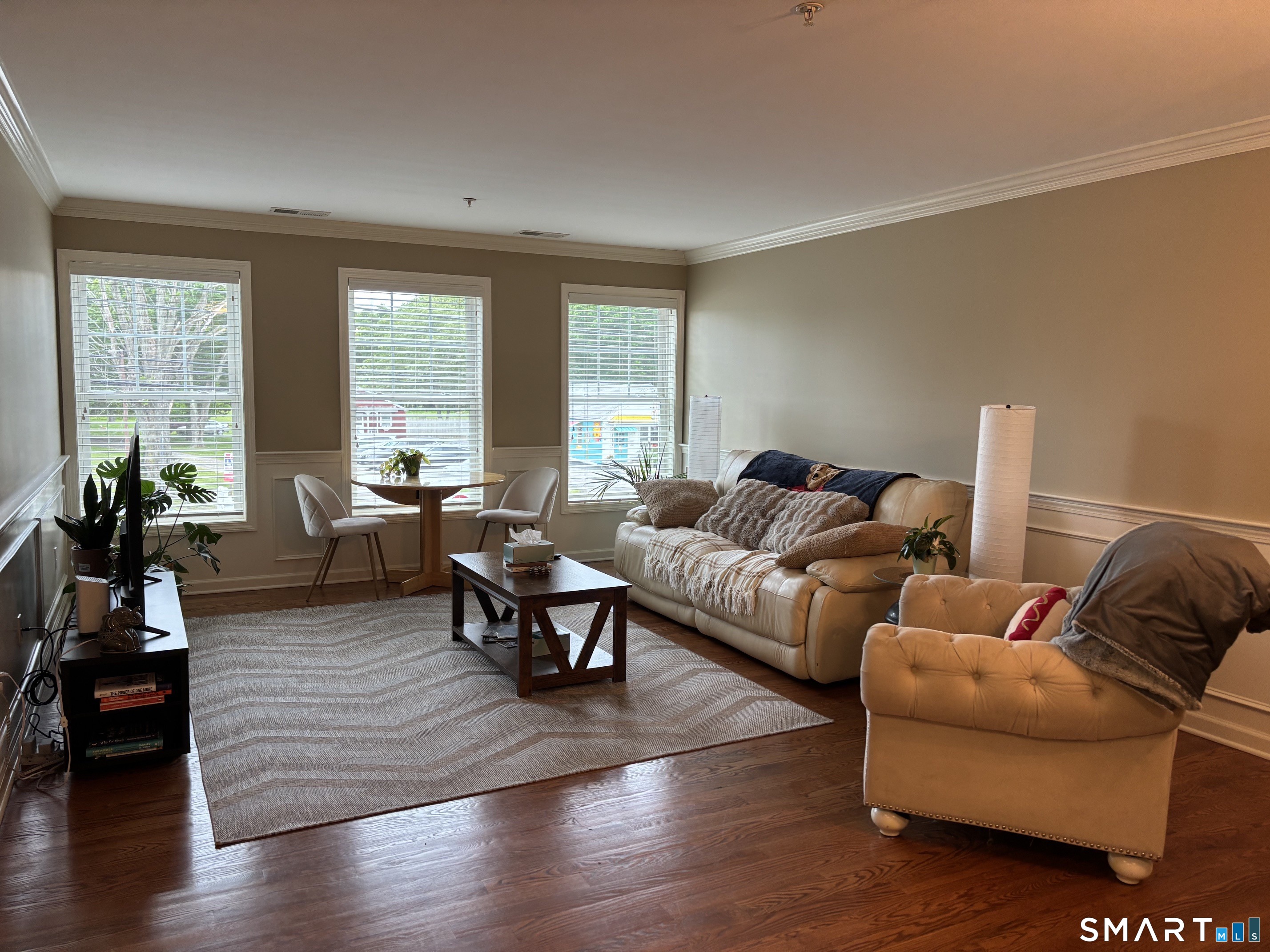 67 West Main Street, Unit 122 Clinton, CT 06413 - Photo 3 of 14 a living room with furniture wooden floor and a large window