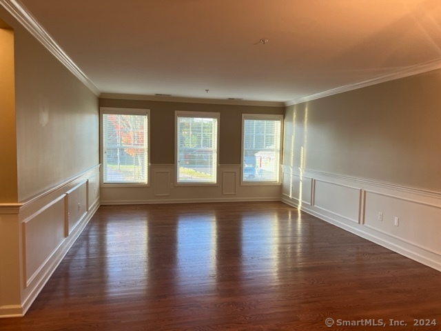 67 West Main Street, Unit 122 Clinton, CT 06413 - Photo 5 of 14 an empty room with wooden floor and windows