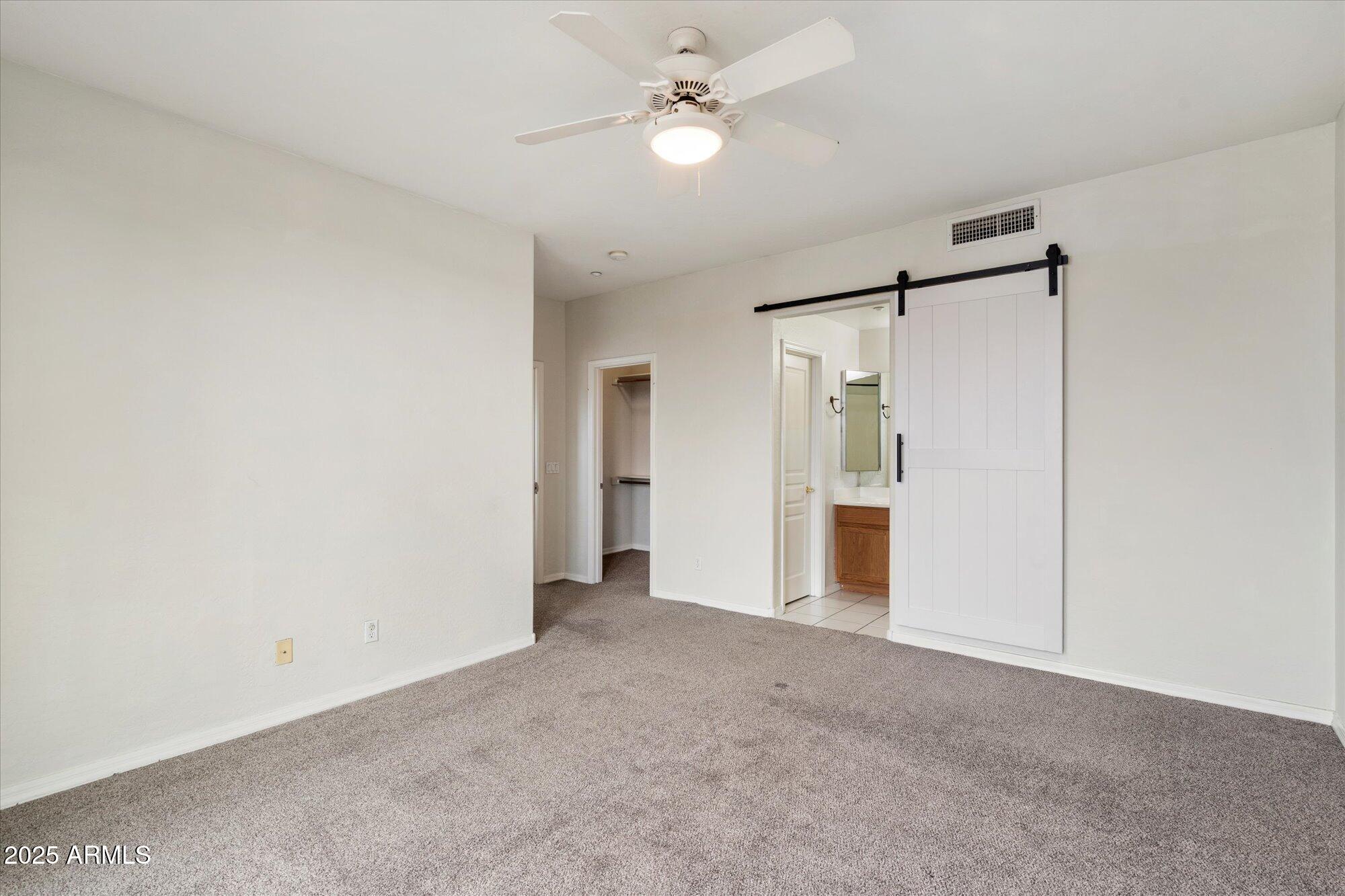 2019 East Campbell Avenue, Unit 125 Phoenix, AZ 85016 - Photo 11 of 21 an empty room with fan and entrance