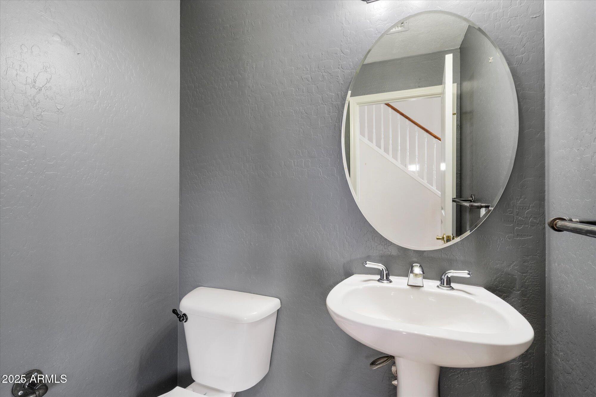 2019 East Campbell Avenue, Unit 125 Phoenix, AZ 85016 - Photo 19 of 21 a bathroom with a toilet sink and mirror