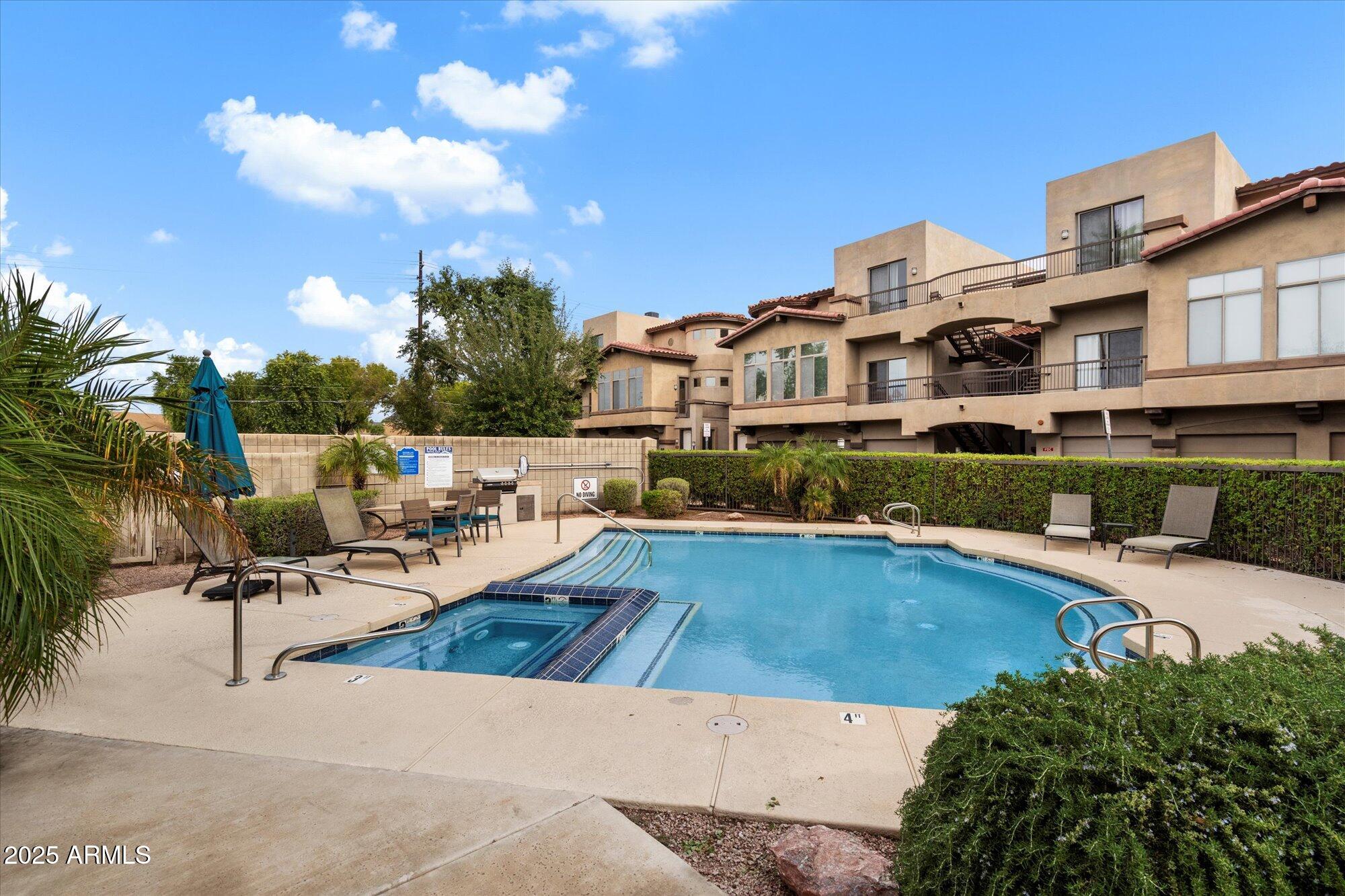 2019 East Campbell Avenue, Unit 125 Phoenix, AZ 85016 - Photo 3 of 21 a view of a swimming pool with lounge chairs