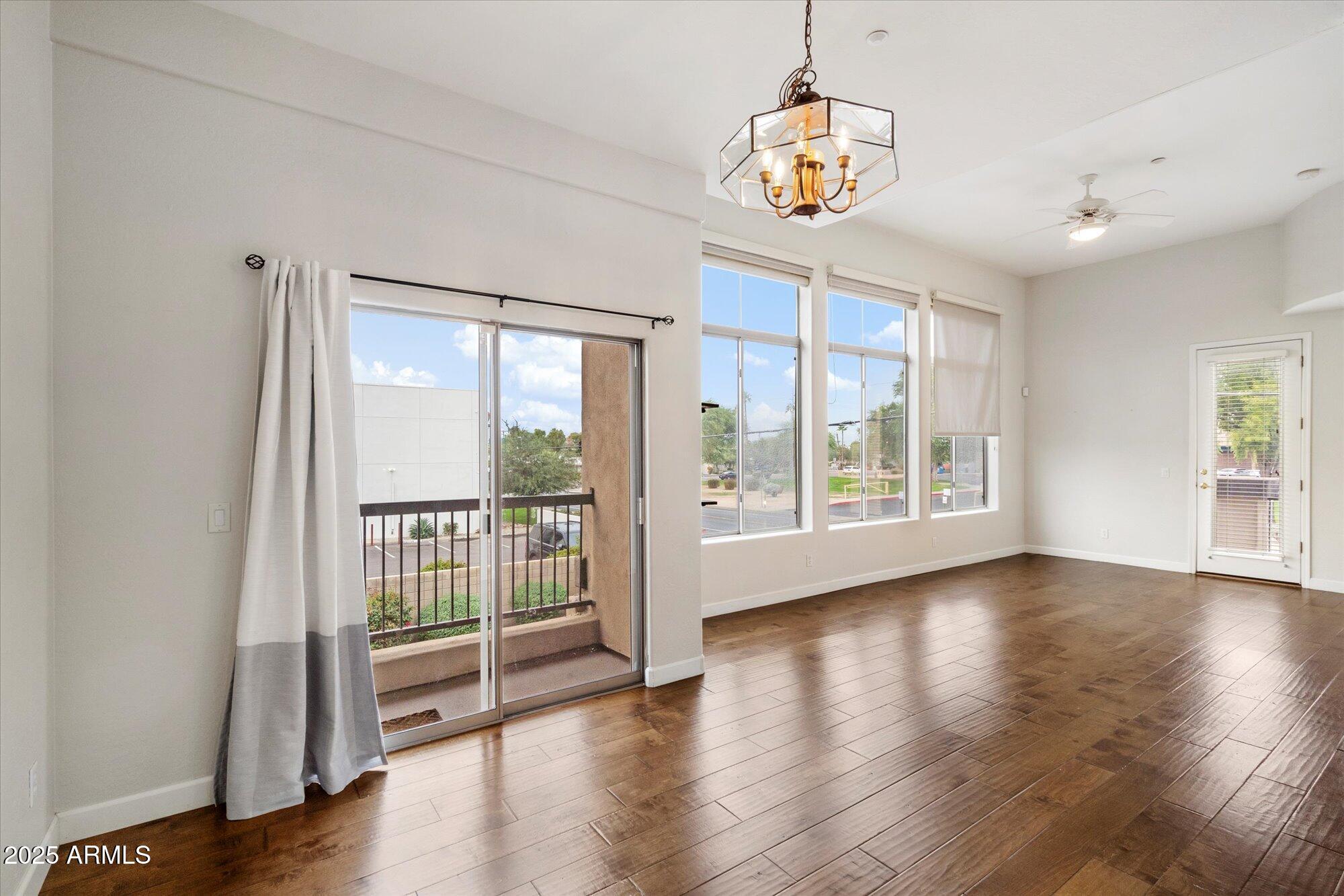 2019 East Campbell Avenue, Unit 125 Phoenix, AZ 85016 - Photo 4 of 21 a view of an empty room with wooden floor and a window