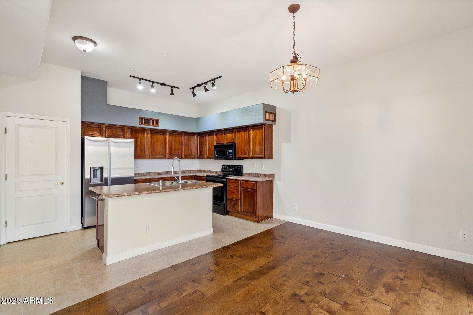 2019 East Campbell Avenue, Unit 125 Phoenix, AZ 85016 - Photo 6 of 21 a kitchen with stainless steel appliances granite countertop a sink a stove and a refrigerator
