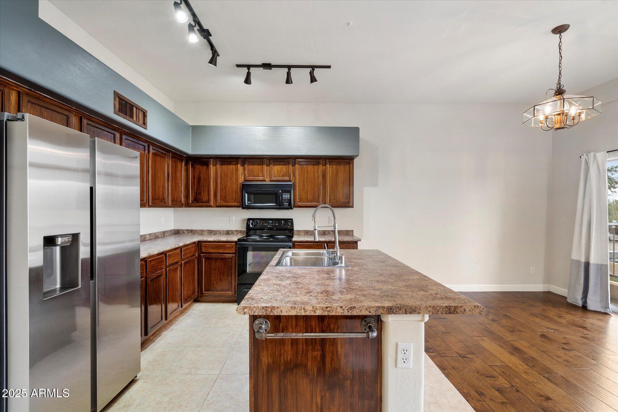 2019 East Campbell Avenue, Unit 125 Phoenix, AZ 85016 - Photo 8 of 21 a kitchen with kitchen island granite countertop stainless steel appliances and a counter space