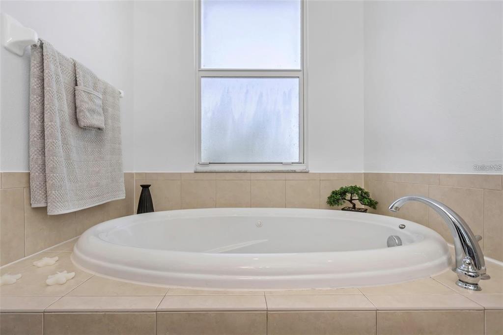 7327 Brightwaters Court New Port Richey, FL 34652 - Photo 18 of 45 a white bath tub sitting next to a white cabinet