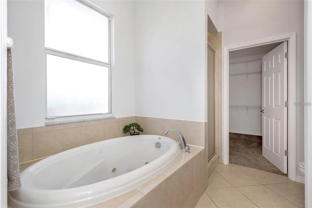 7327 Brightwaters Court New Port Richey, FL 34652 - Photo 19 of 45 a white bath tub sitting in a bathroom