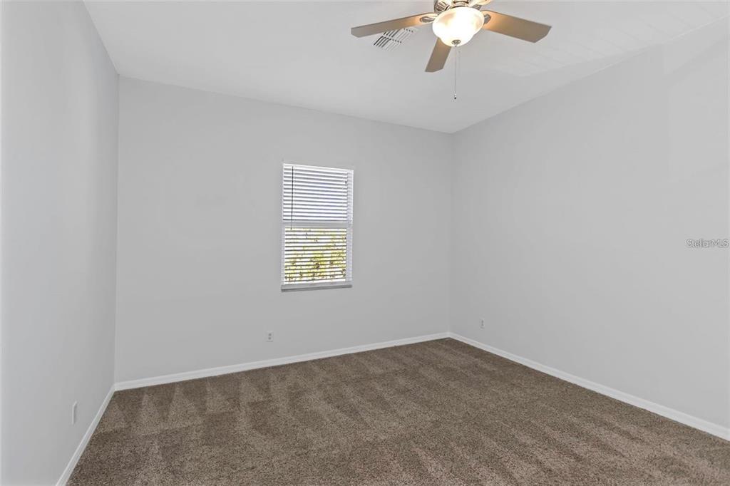 7327 Brightwaters Court New Port Richey, FL 34652 - Photo 24 of 45 an empty room with a chandelier fan
