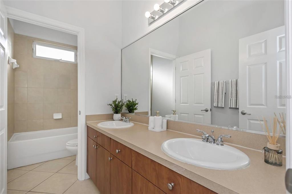 7327 Brightwaters Court New Port Richey, FL 34652 - Photo 25 of 45 a bathroom with a tub sink and mirror