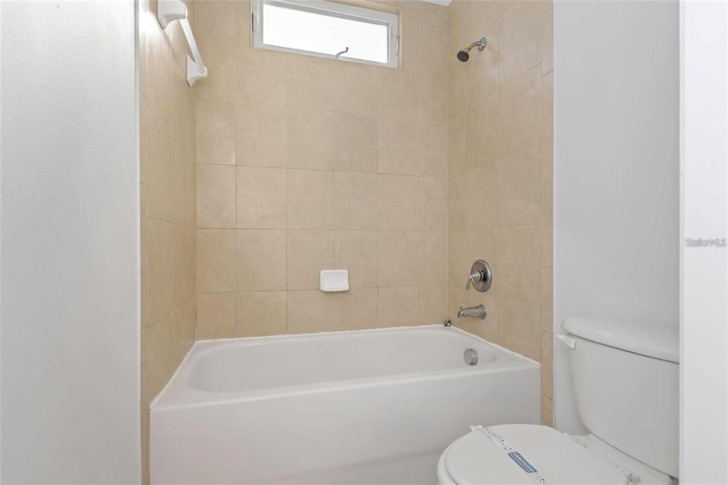 7327 Brightwaters Court New Port Richey, FL 34652 - Photo 26 of 45 a white bath tub sitting next to a white toilet