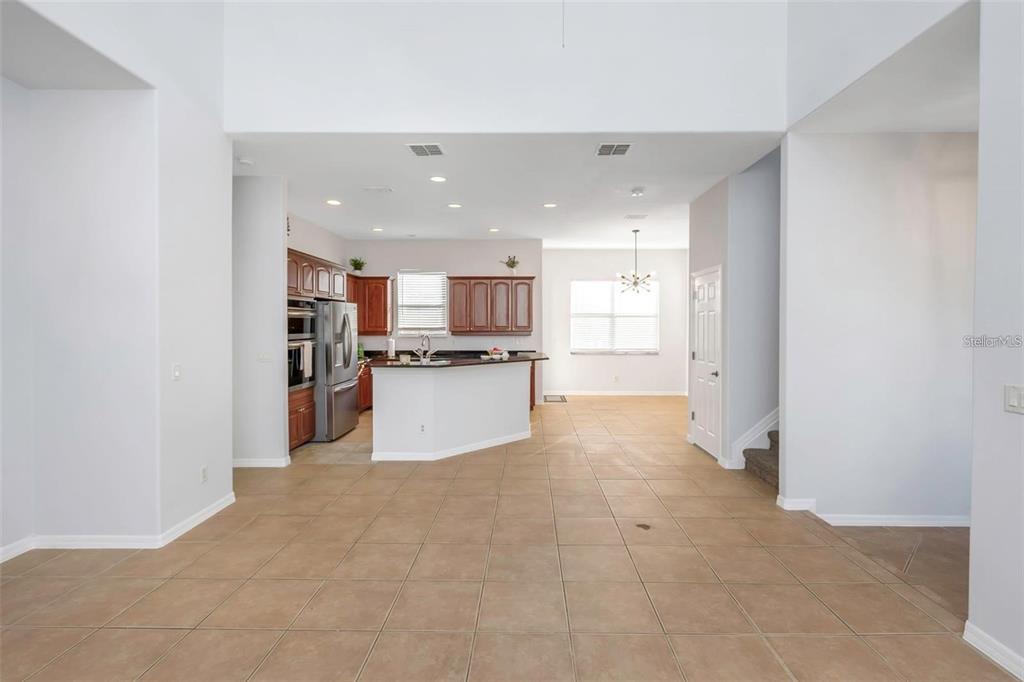 7327 Brightwaters Court New Port Richey, FL 34652 - Photo 4 of 45 a view of kitchen with refrigerator sink microwave and cabinets