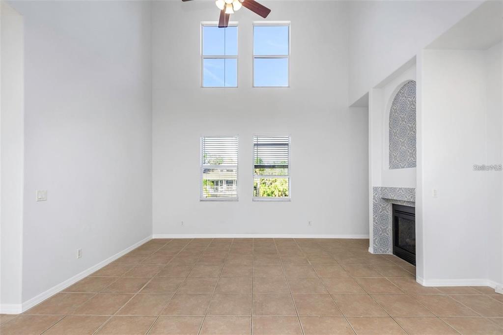 7327 Brightwaters Court New Port Richey, FL 34652 - Photo 7 of 45 an empty room with windows and fireplace