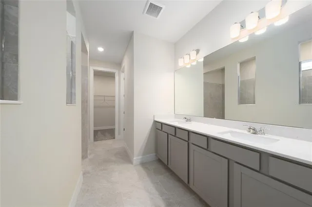 a bathroom with a sink double vanity and a mirror