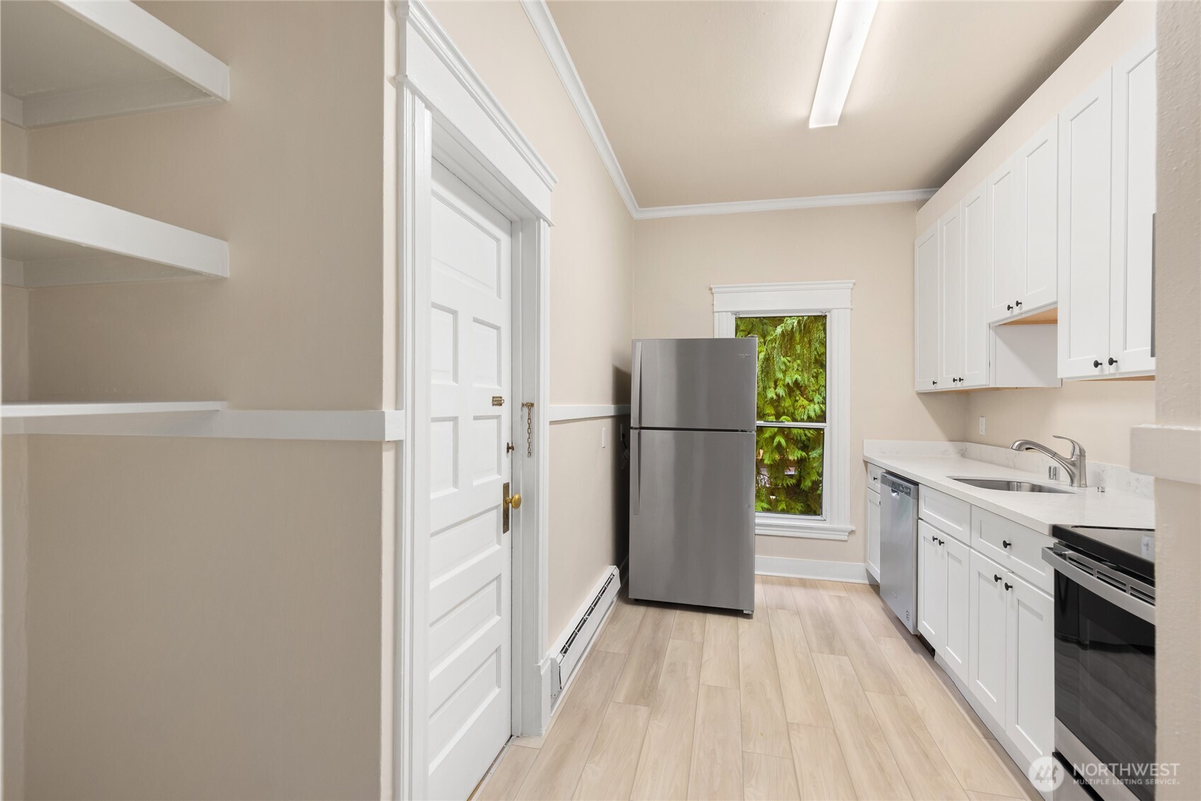3722 Oakes Avenue Everett, WA 98201 - Photo 18 of 27 a kitchen with a refrigerator a stove top oven and cabinets