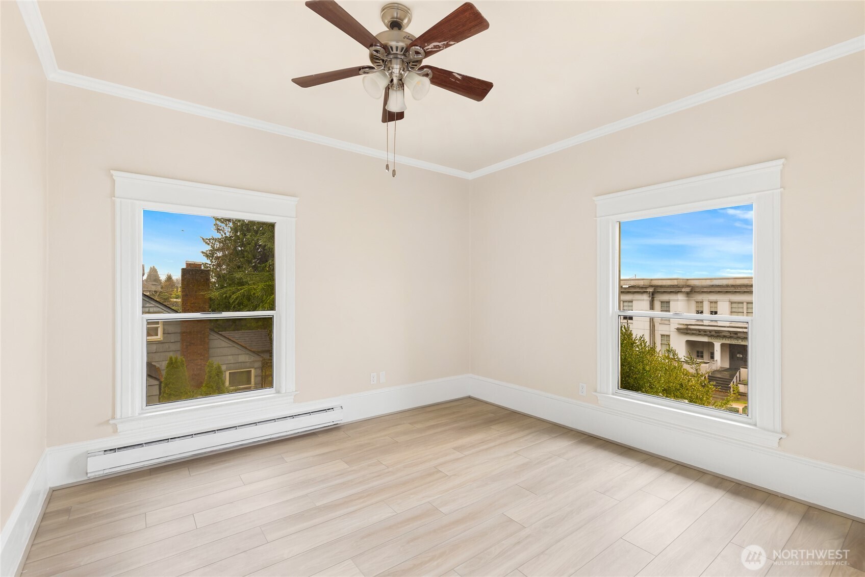 3722 Oakes Avenue Everett, WA 98201 - Photo 22 of 27 an empty room with wooden floor chandelier fan and windows