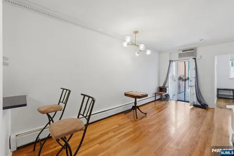 a view of a room with furniture and wooden floor
