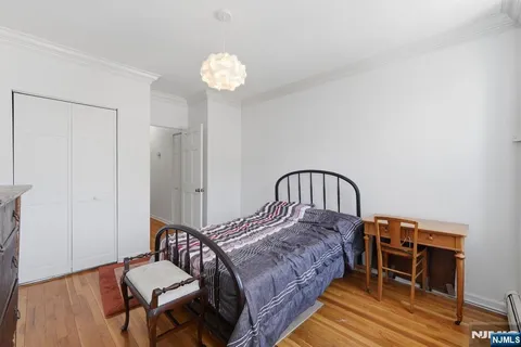 a bedroom with a bed and a chandelier