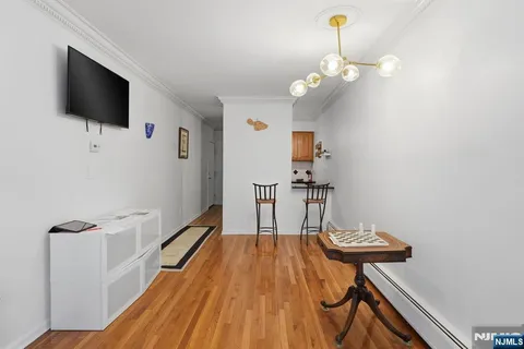 a view of a livingroom with wooden floor and a ceiling fan