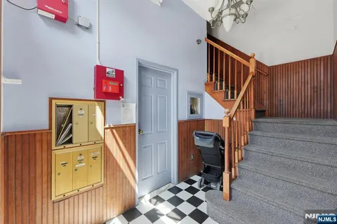 a view of a hallway with wooden floor and entryway