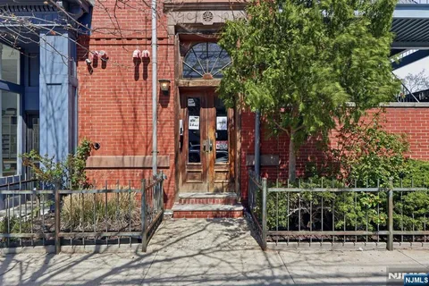 a view of a brick house with plants