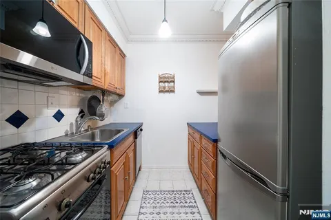 a kitchen with stainless steel appliances granite countertop a stove and a refrigerator