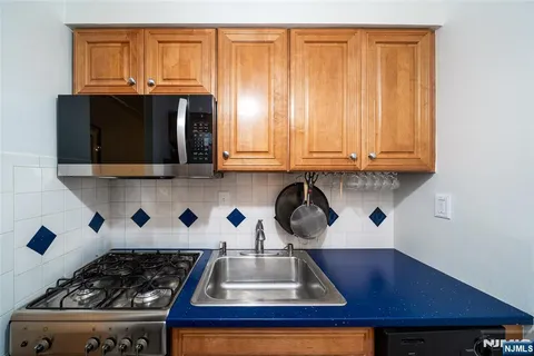 a kitchen with a sink a stove and a microwave