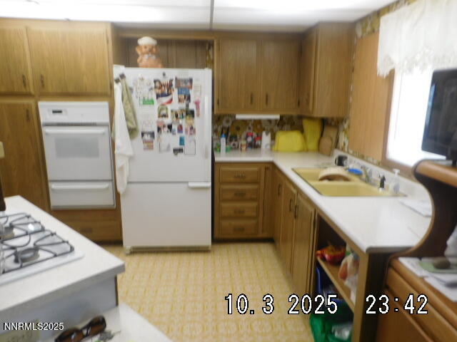 12085 Albert Way Reno, NV 89506 - Photo 6 of 14 a kitchen with a refrigerator and a sink