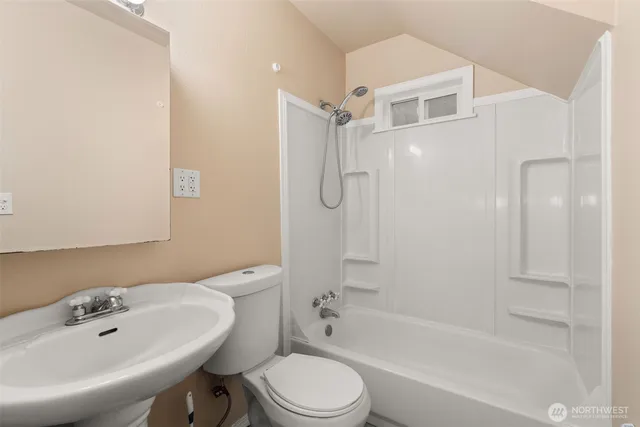 a view of a bathroom from a corridor