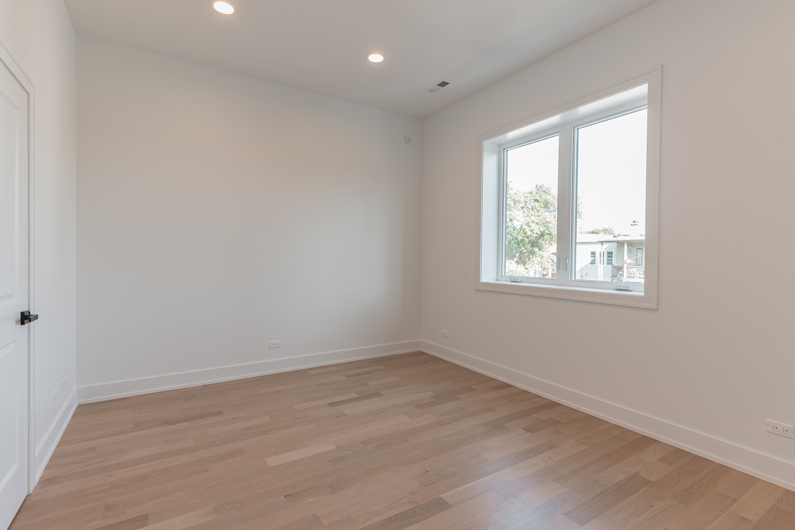 2714 West Cortez Street, Unit 3 Chicago, IL 60622 - Photo 12 of 22 an empty room with wooden floor and windows