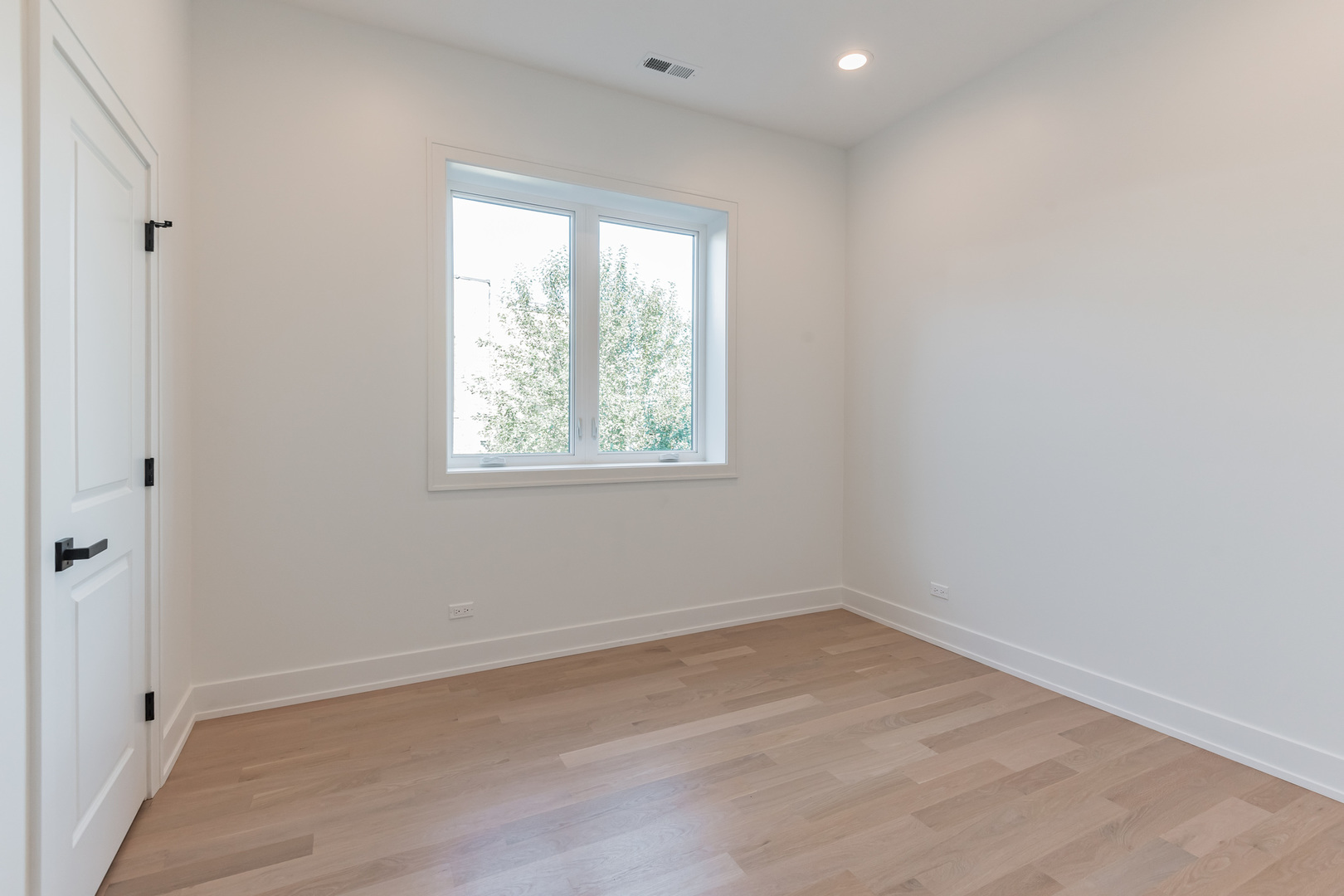 2714 West Cortez Street, Unit 3 Chicago, IL 60622 - Photo 13 of 22 wooden floor in an empty room with a window