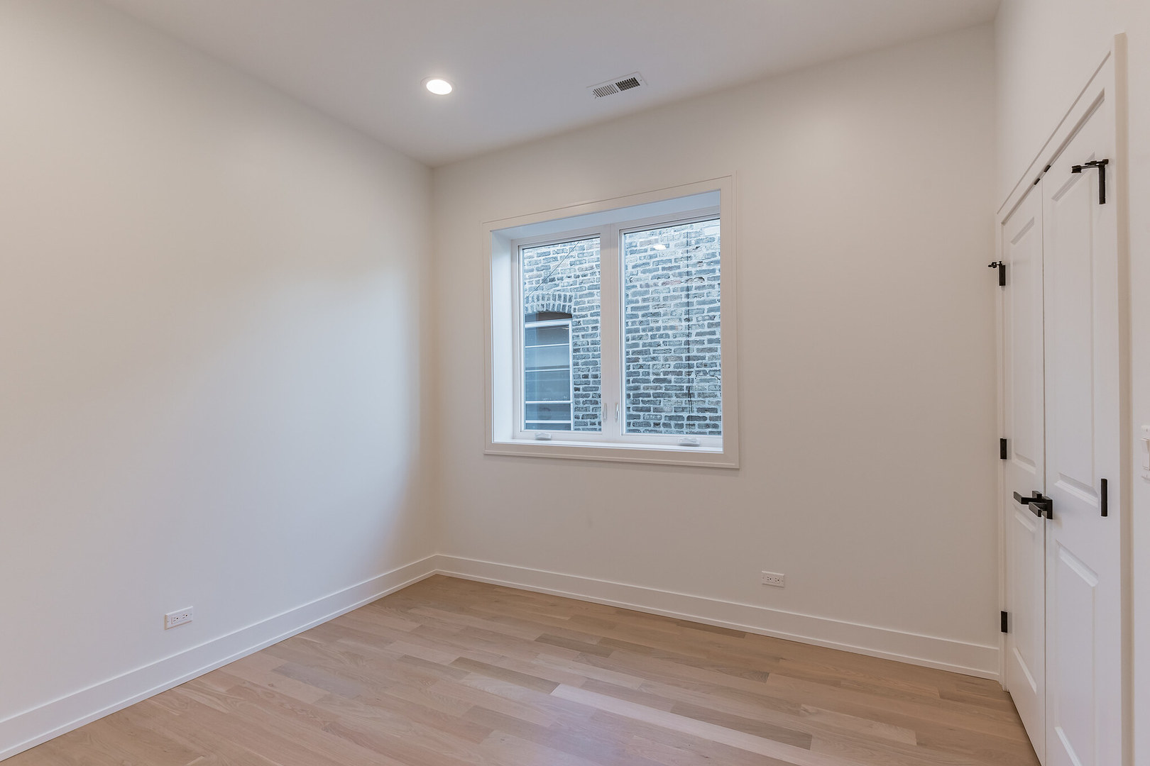 2714 West Cortez Street, Unit 3 Chicago, IL 60622 - Photo 14 of 22 a view of an empty room with wooden floor and a window