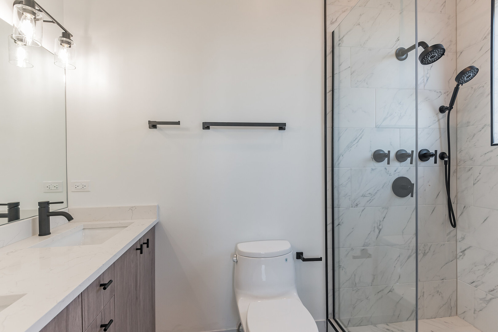 2714 West Cortez Street, Unit 3 Chicago, IL 60622 - Photo 7 of 22 a bathroom with a shower sink vanity and toilet