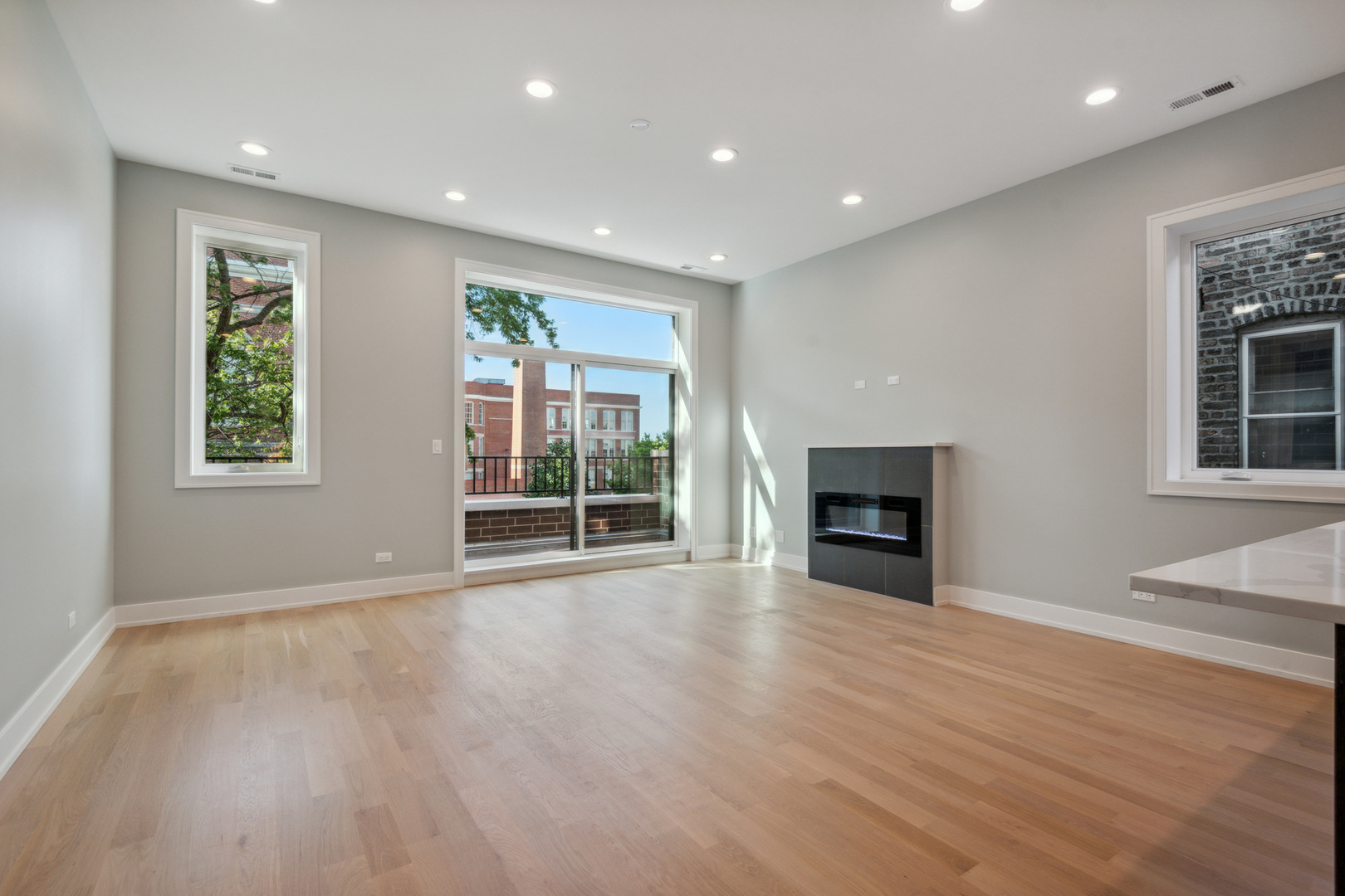 2714 West Cortez Street, Unit 3 Chicago, IL 60622 - Photo 10 of 22 an empty room with wooden floor and fireplace