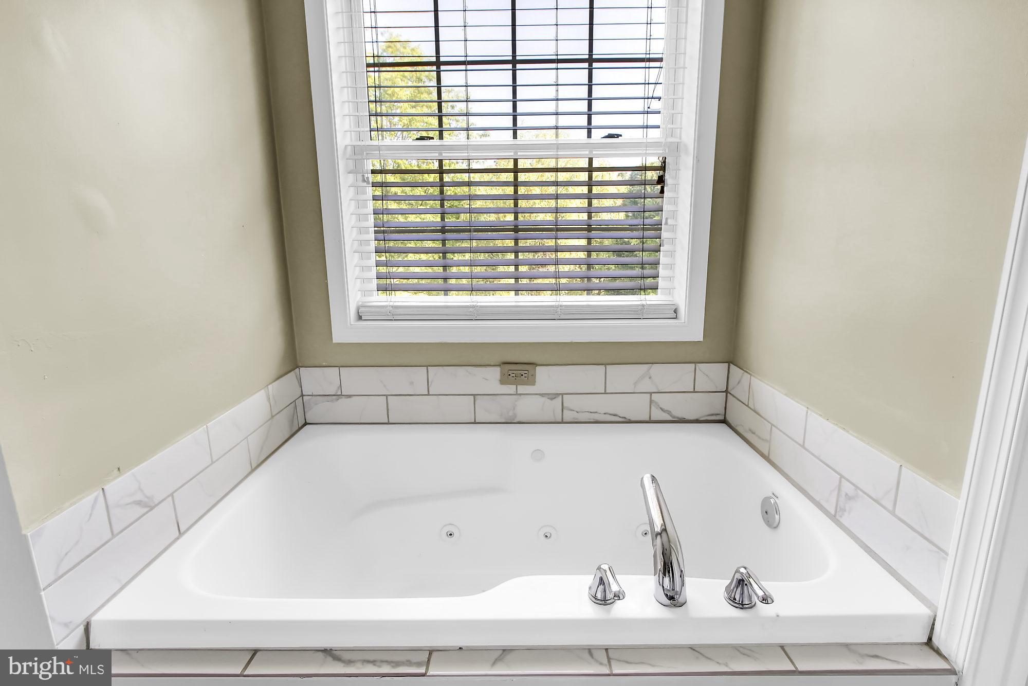 2260 Garrett Road Hanover, PA 17331 - Photo 22 of 35 a white bath tub sitting in a bathroom next to a window