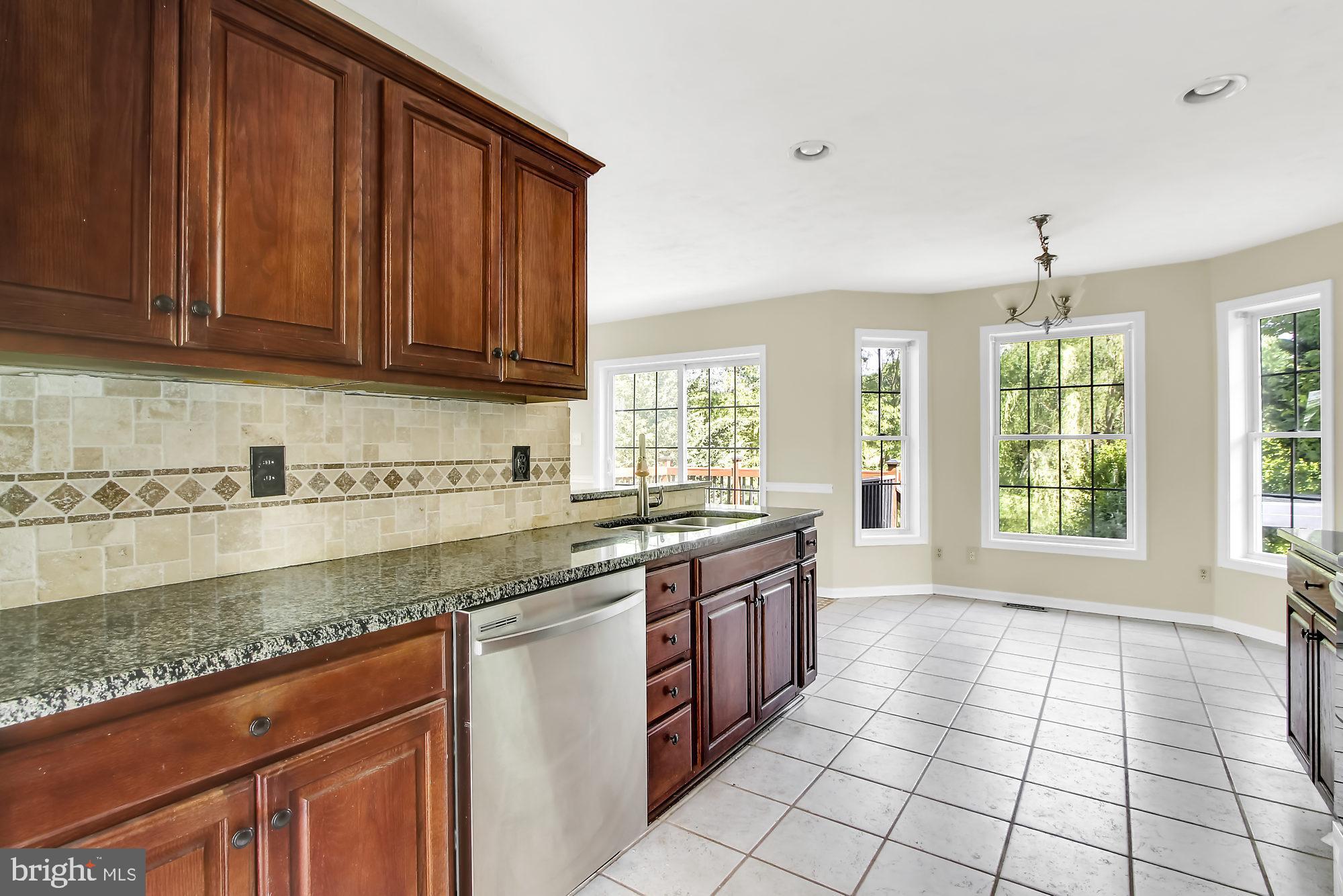 2260 Garrett Road Hanover, PA 17331 - Photo 8 of 35 a large kitchen with granite countertop a stove sink and cabinets